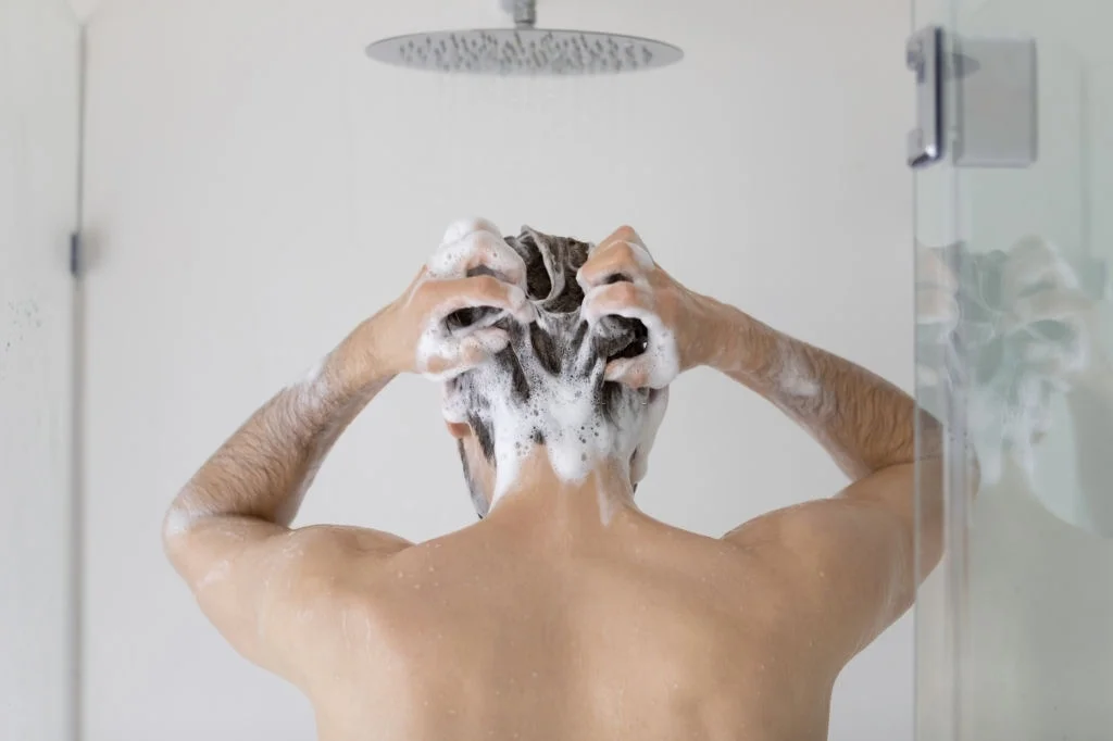 Washing your hair with foamy anti-dandruff shampoo helps
